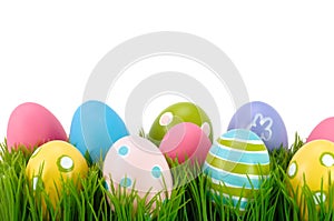 Easter colored eggs on the grass.