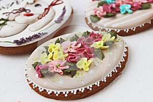 Easter colored gingerbread in the shape of an egg with a rabbit and flowers drawn on them