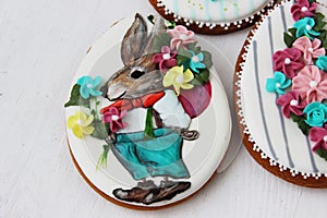 Easter colored gingerbread in the shape of an egg with a rabbit and flowers drawn on them