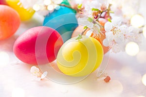 Easter colorful eggs background. Beautiful colorful eggs over white wooden background