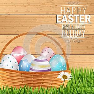 Easter colorful eggs in basket with field of grass on wooden background