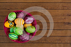 Easter colorful eggs in basket, top view