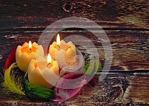 Easter composition with burning candles and feathers