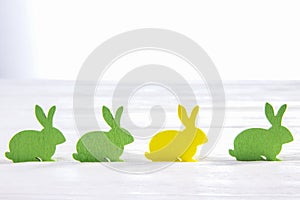 Easter composition. Colored Bunny on a white background