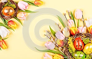 Easter composition with Easter eggs in nest and  spring flowers