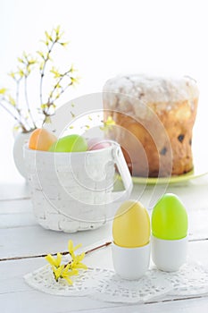 Easter composition with eggs holiday cake and flowering branches on wooden
