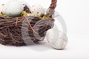 Easter composition with quail eggs in basket on a wooden backround. Top view. Holiday card.