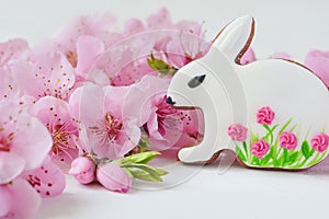 Easter concept. gingerbread bunny surrounded by spring flowers