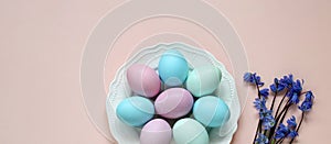 Easter concept, painted eggs in pastel colors. flat lay, top view. pink background.