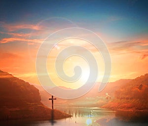 Easter concept:Silhouette cross on Calvary mountain sunset background. photo