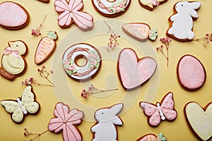 Easter cookies background among gypsophila. Baked glazed symbols of Easter. Spring easter card top view.