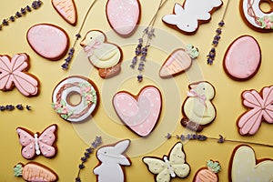 Easter cookies background with lavender. Baked glazed symbols of Easter. Spring easter card top view.