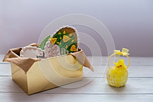 Easter cookies in a box on grey wooden background