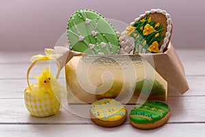 Easter cookies in a box on grey wooden background with chik