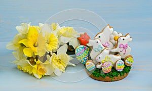 Easter cookies white bunny and colored eggs with a bouquet of ye