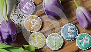 Easter cookies words alphabet wood background message tulips flowers