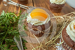 Easter cupcake on wooden background with Peach looks like a fried egg