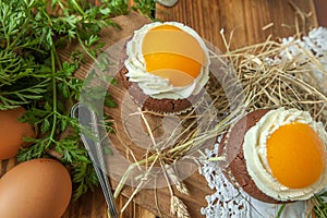 Easter cupcake on wooden background with Peach looks like a fried egg