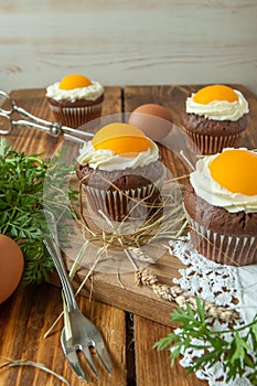 Easter cupcake on wooden background with Peach looks like a fried egg
