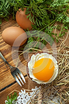 Easter cupcake on wooden background with Peach looks like a fried egg