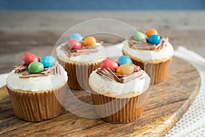 Easter cupcakes with chocolate frosting and candy eggs