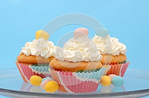 Easter cupcakes topped with pastel colored chocolate candy eggs