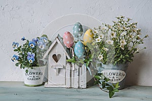 Easter decor with bird house and spring flowers