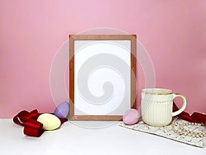 Easter decor with blank frame mockup on pink wall
