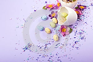 Easter decor in pastel colors. Easter eggs, candy, sweets, flowers and eggshells