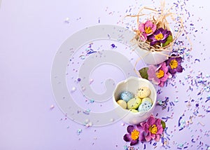 Easter decor in pastel colors. Easter eggs, candy, sweets, flowers and eggshells.