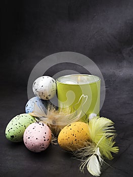 Easter decoration. Colorful eggs and burning candle with rabbit
