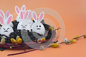Easter decoration with eggs in the form of rabbits surrounded by willow branches