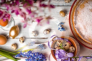 Easter decoration , flowers and German Easter cake on the white wooden table