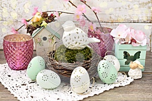 Easter decoration with porcelain bird in nest and eggs