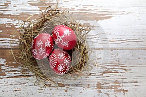 Easter decorations. Eggs in nests on wood