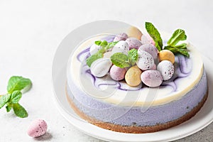 Easter dessert. Berry cheesecake decorated with Easter chocolate eggs