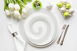 Easter dinner. Table setting with white tulip on table. Top view