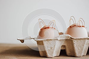 Easter DIY egg, made in bunny style. Minimal Easter concept, idea with rabbit. Craft hipster holiday package, carton box