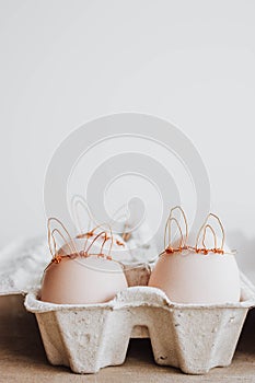 Easter DIY egg, made in bunny style. Minimal Easter concept, idea with rabbit. Craft holiday package, carton box