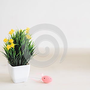 Easter. Easter background with eggs.  A pot with a flower and a pink egg