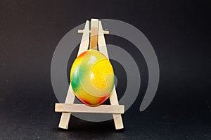 Easter egg on artist Easel, Black Background