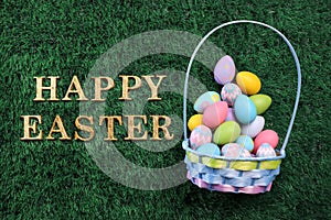 Easter egg basket with Happy Easter text on grass