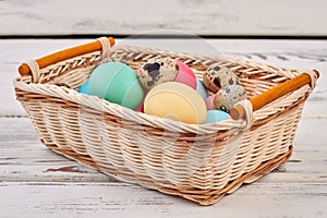 Easter egg basket on wood.