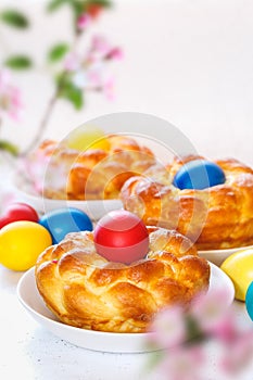 Easter Egg bread with dyed eggs on the table and ready to eat