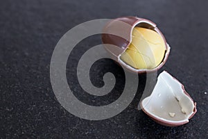 Easter egg for children with yellow surprise inside. Chocolate e