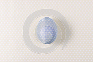 Easter egg decorated with blue paper napkin.