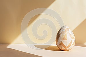 an easter egg with a geometric pattern is sitting on a table