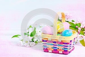 Easter Egg Hunt Basket on White Table with Spring Blossoms with White Shiplap Board Background with room or space for copy, text,