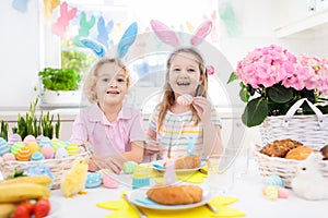 Easter egg hunt. Kids with bunny ears and basket.