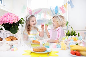 Easter egg hunt. Kids with bunny ears and basket.